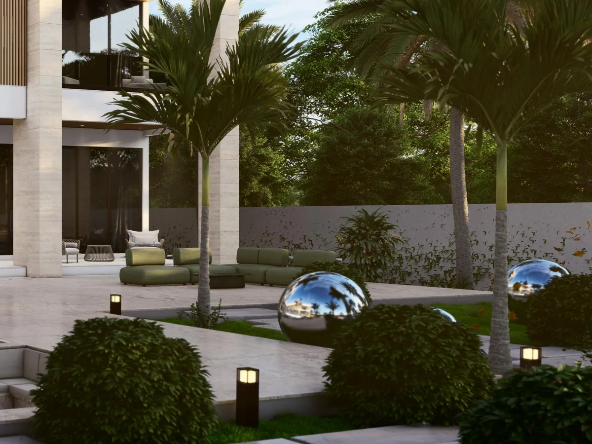 Palm-shaded outdoor lounge with sculptural accents at a Kingdom Development estate